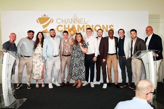 Winners of an award holding a trophy