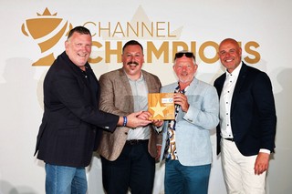 Winners of an award holding a trophy