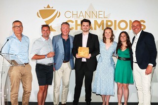 Winners of an award holding a trophy