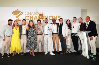 Winners of an award holding a trophy