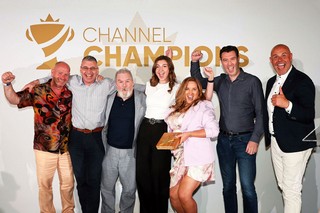 Winners of an award holding a trophy