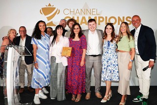 Winners of an award holding a trophy